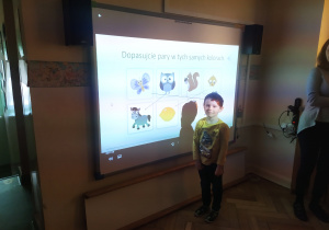 Dzieci zaznaczają na tablicy interaktywnej elementy o jednakowym kolorze