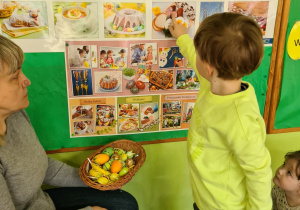 Dziecko wskazuje ilustrację wielkanocną.